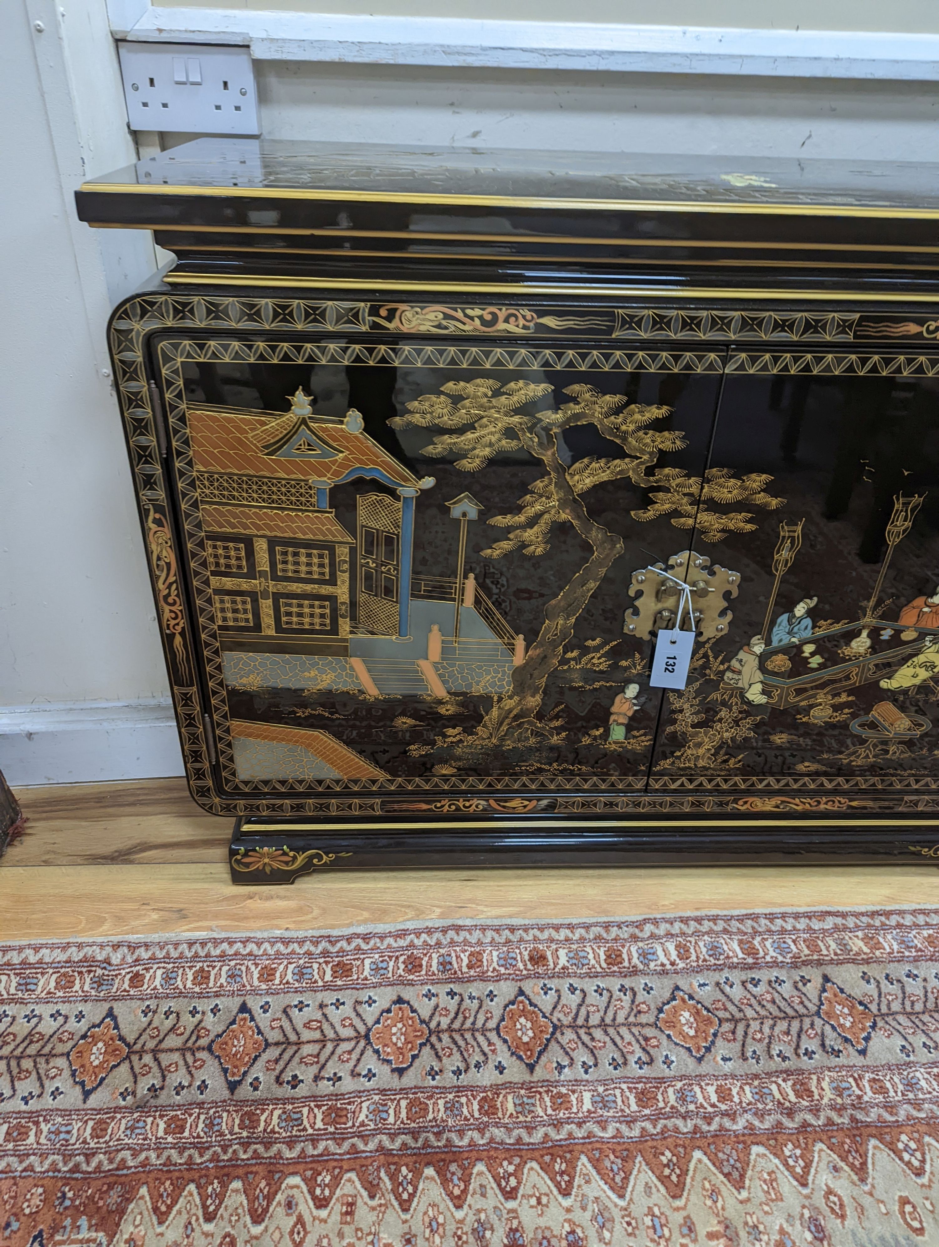 A Chinese lacquer decorated low cabinet. W-200cm, D-45cm, H-75cm.